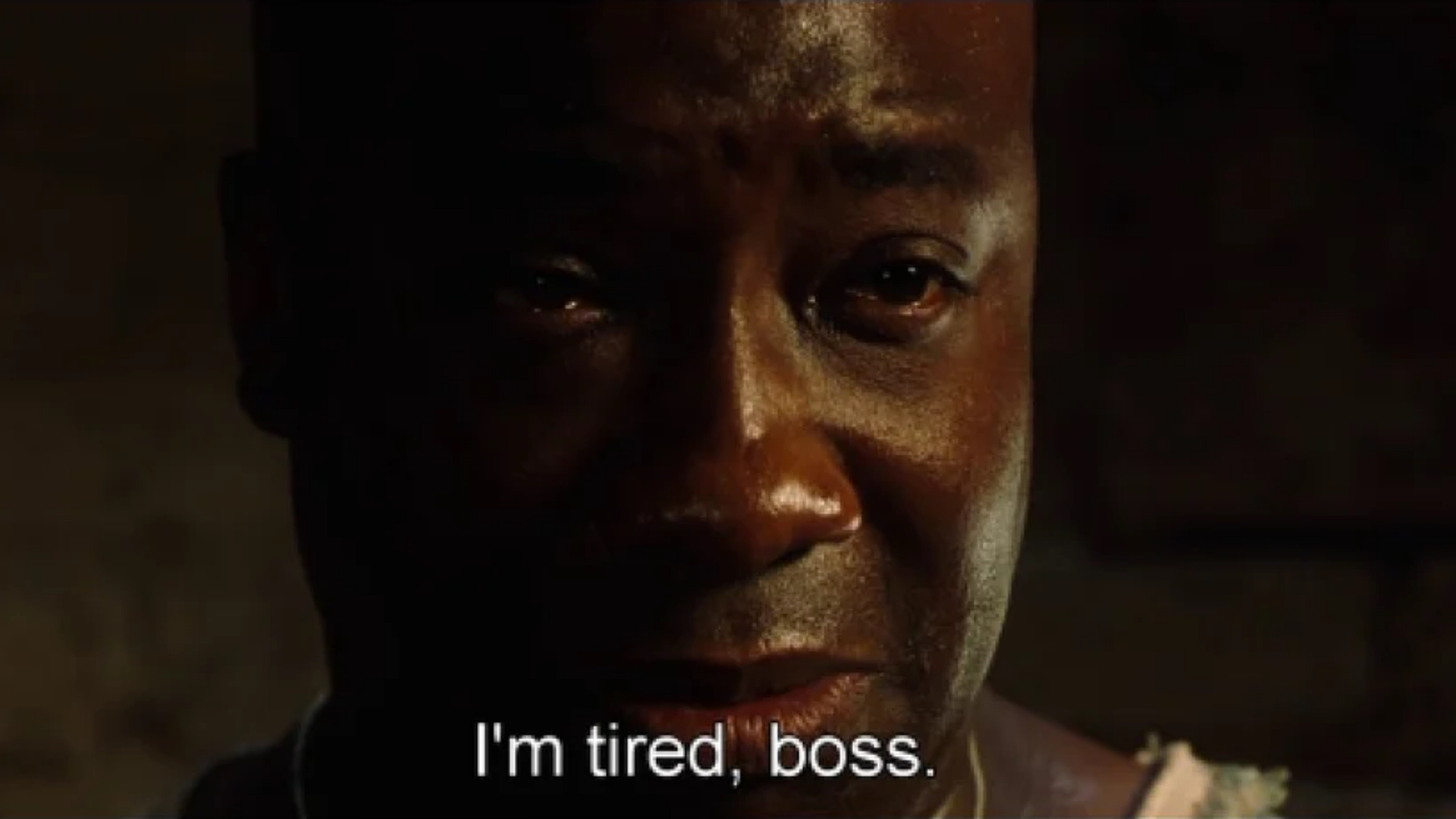 A screenshot from a movie. It shows a person crying. They look exhausted and defeated. It is captioned with: "I'm tired, boss."