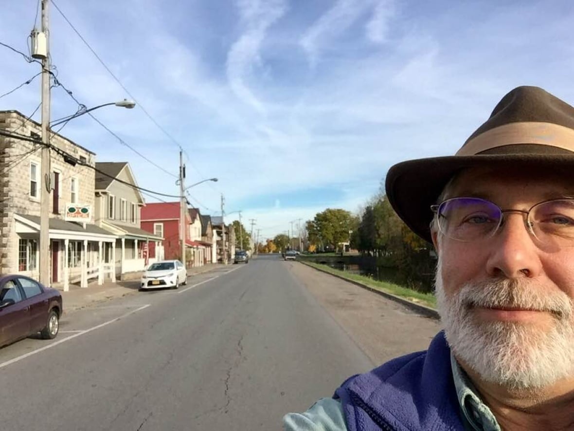 Man takes selfie on city street