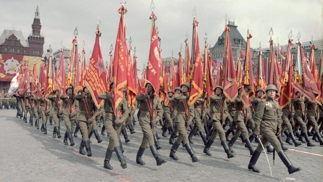 soviet may 1st parade with a procession of soldiers holding red flags