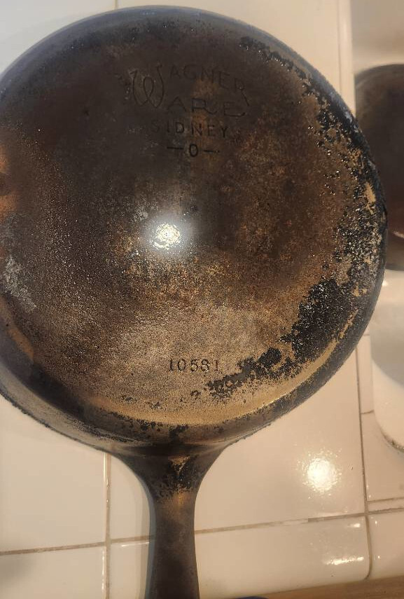 the 10-inch skillet after stripping with a wire brush, with "Wagner Ware Sidney" and "1058 1" visible in the inscription