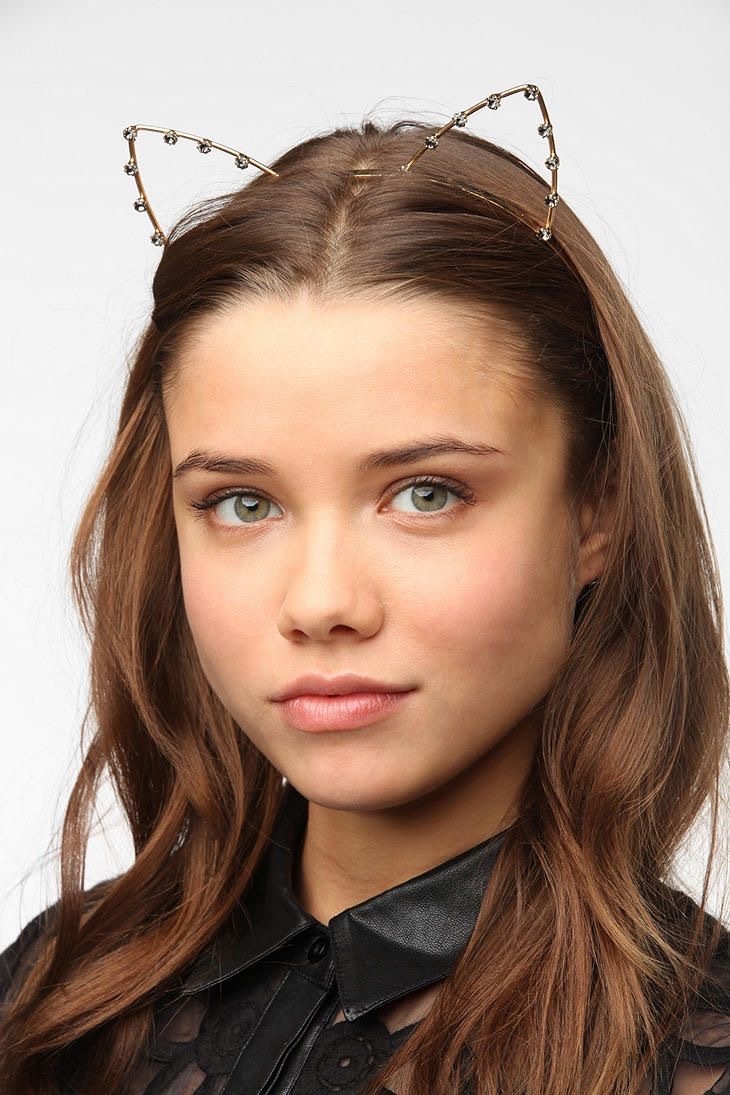 girl wearing a bejeweled car ear headband.