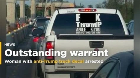 picture of a white truck’s back window with the words “fuck Trump and fuck you for voting for him” but with the f-words blurred out. Caption says, “Outstanding warrant. Woman with anti-Trump decal arrested.”